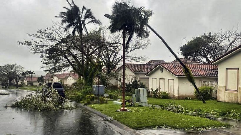 In this photo provided by the U.S. Coast Guard, downed tree branches litter a neighborhood in Yona, Guam, Thursday, May 25, 2023, after Typhoon Mawar passed over the island. The powerful typhoon smashed the U.S. territory of Guam and continued lashing the Pacific island with high winds and heavy rain Thursday, knocking down trees, walls and power lines and creating a powerful storm surge that threatened to wash out low-lying areas. (Chief Warrant Officer Adam Brown/U.S. Coast Guard via AP)